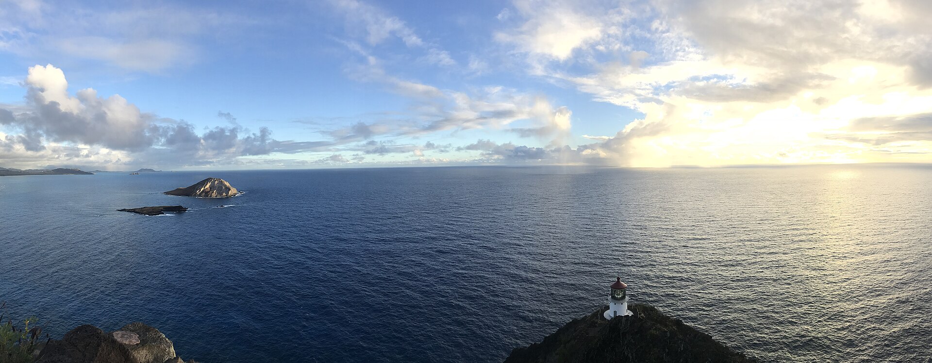 Makapuu Point Lighthouse Trail, Oahu — paved coastal path overlooking the red-roofed lighthouse and sea cliffs